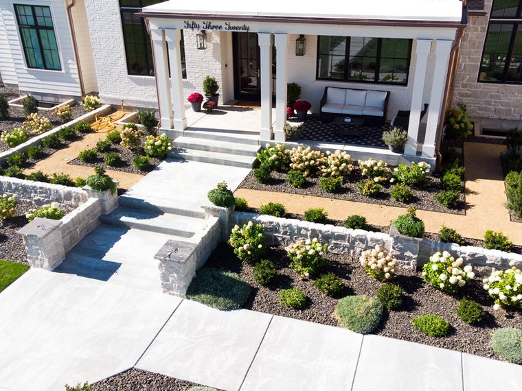 Aerial view of a paver patio and planting beds installed by J&F